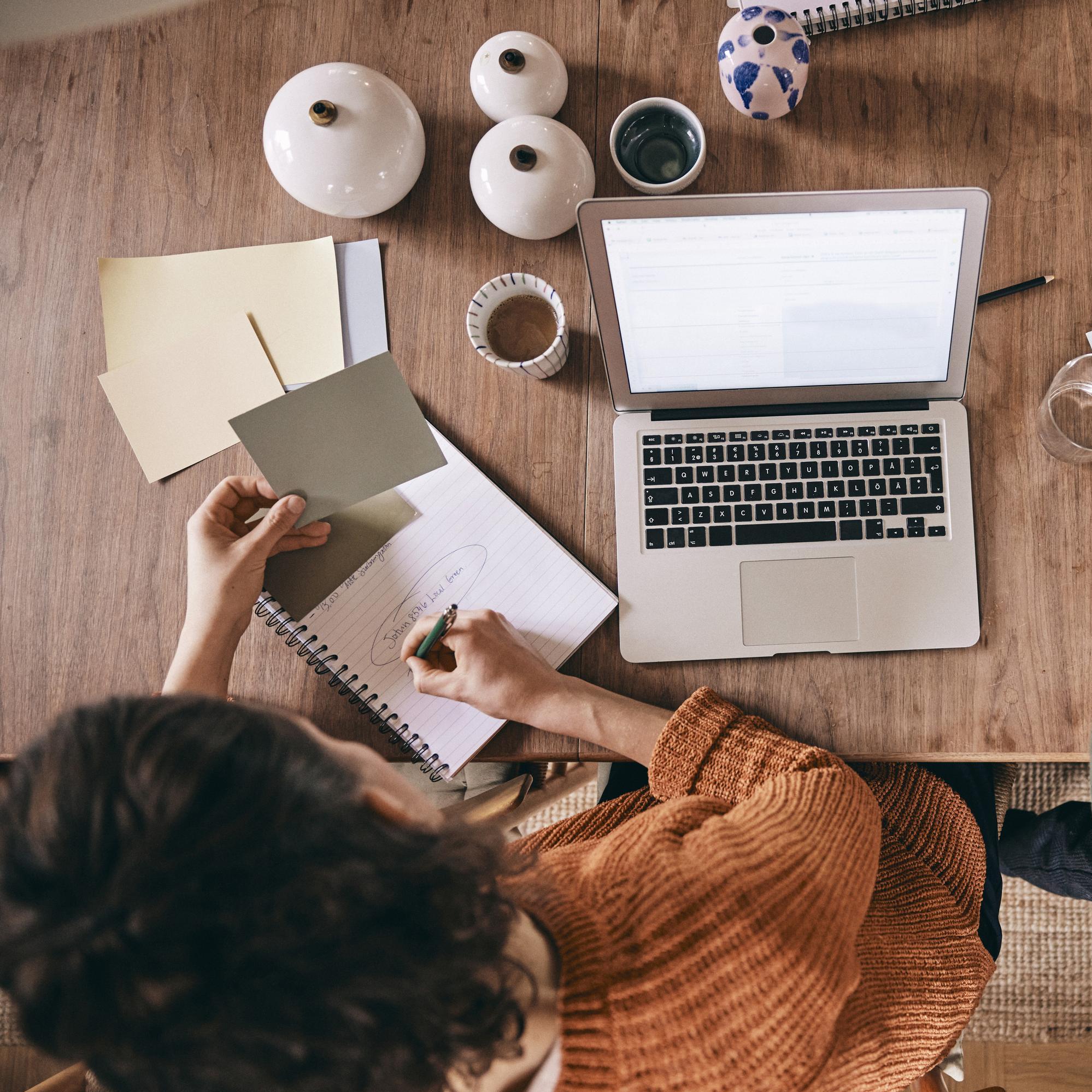 Two people working in front of the computer together