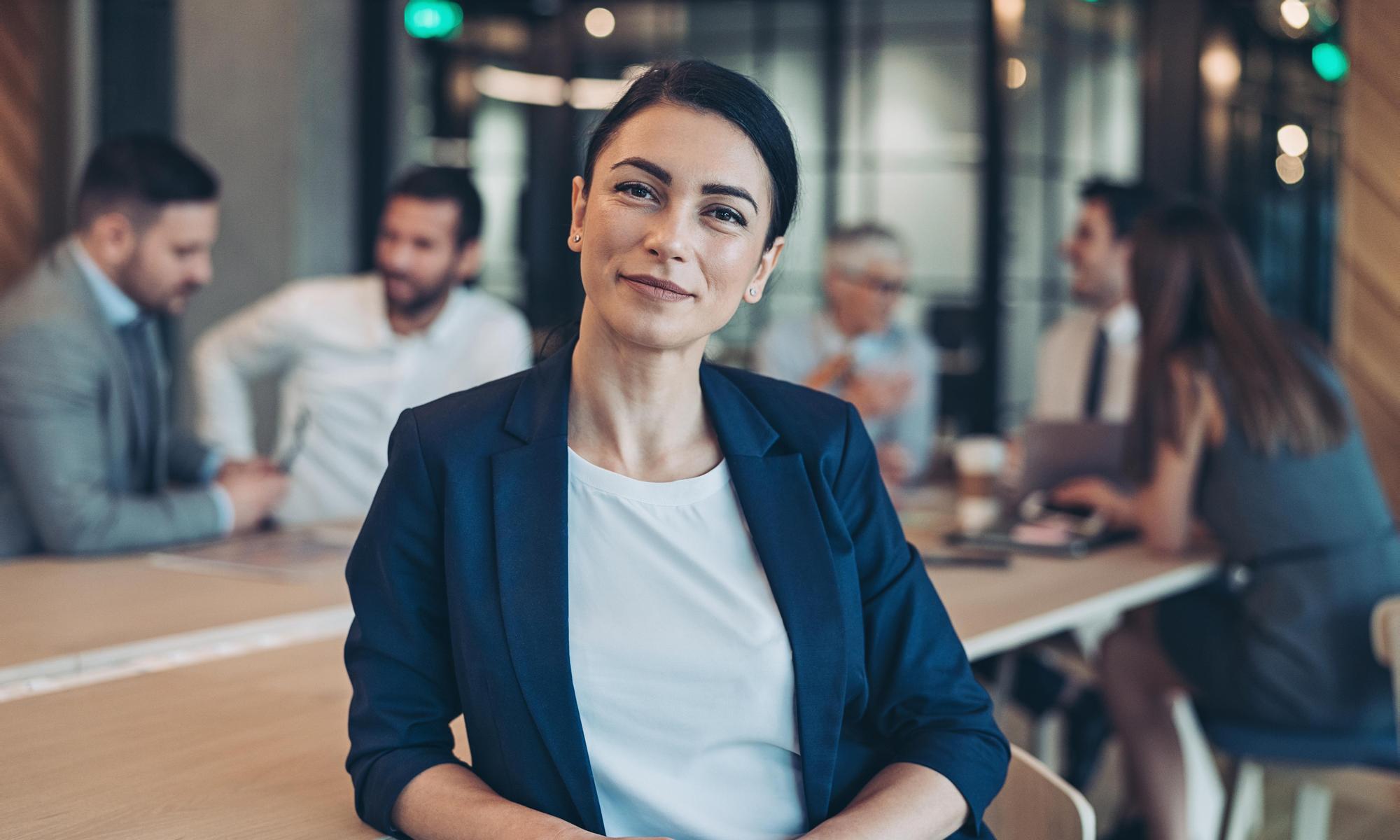 Businesswoman on a meeting with her team behind